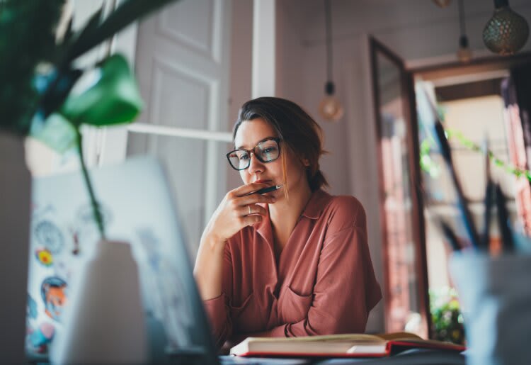 A woman looking at the 10 best email hosting services on her laptop. 