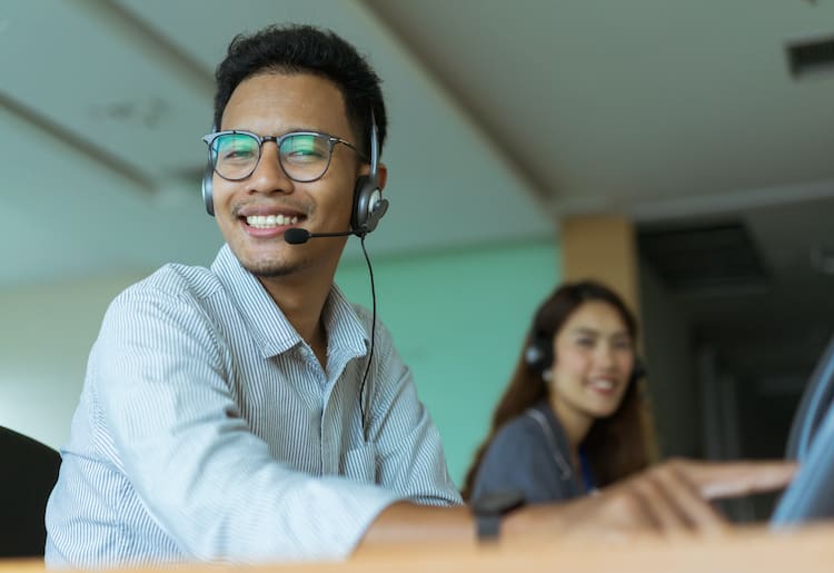 A man happy because he decided to go with VoIP and IoT