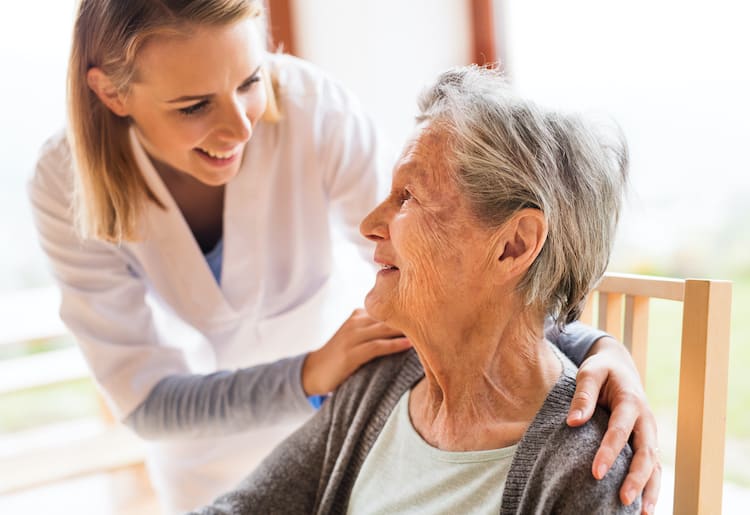 An elderly woman happy because she's using a medical alert system for seniors.